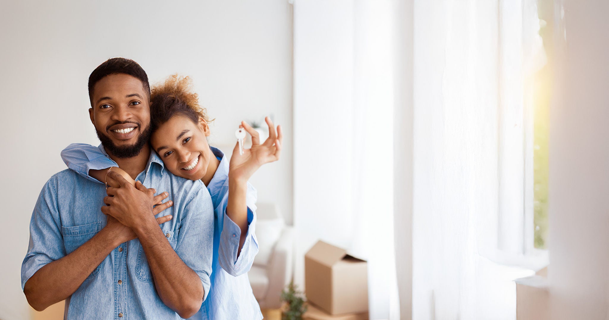 couple smiling with keys