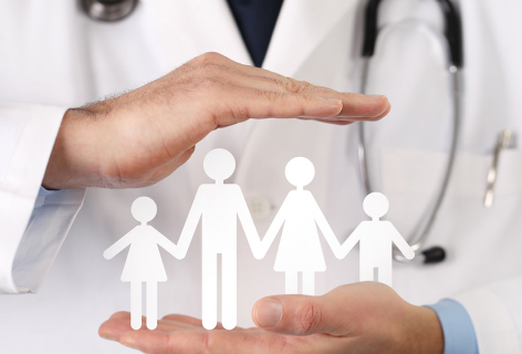 Doctor holding with both hands a paper family