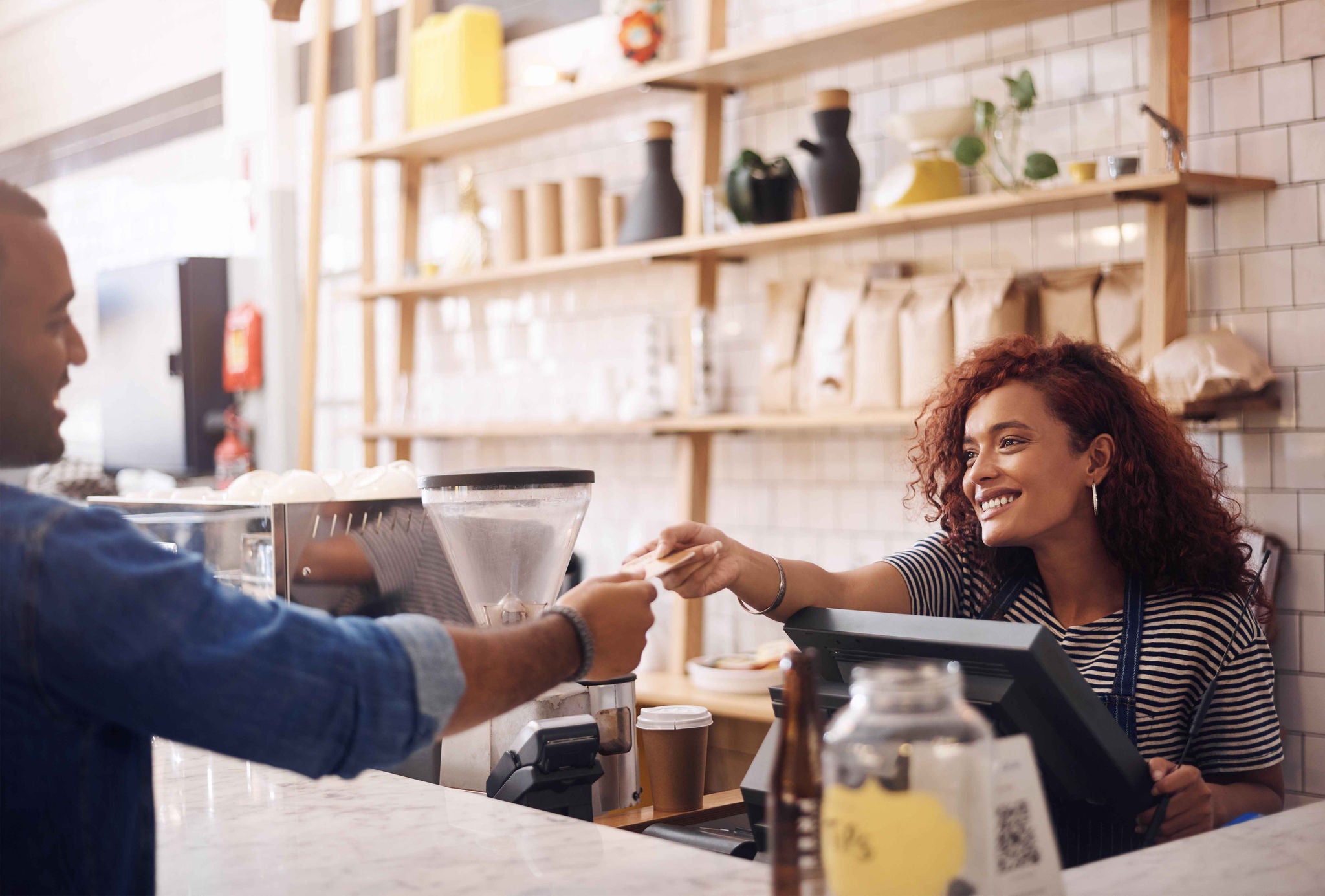 Credit card, coffee shop and happy woman with customer for payment, financial transaction and point of sales service. Finance, trade and bills at cashier in cafe, b2c shopping and restaurant store.