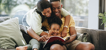 Family simling in a sofa